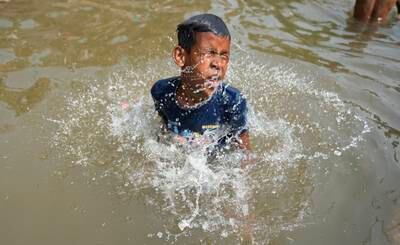 A boy bathes in the Ranbir Canal in Jammu. AP