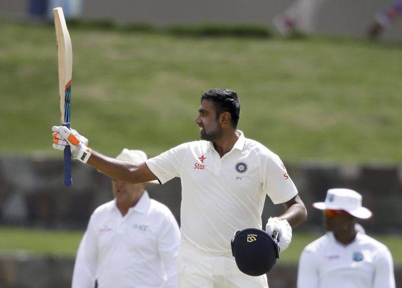 India's Ravichandran Ashwin raises his bat after scoring a century against West Indie's day two of their first cricket Test match at the Sir Vivian Richards Stadium in North Sound, Antigua, Friday, July 22, 2016. (AP Photo/Ricardo Mazalan)