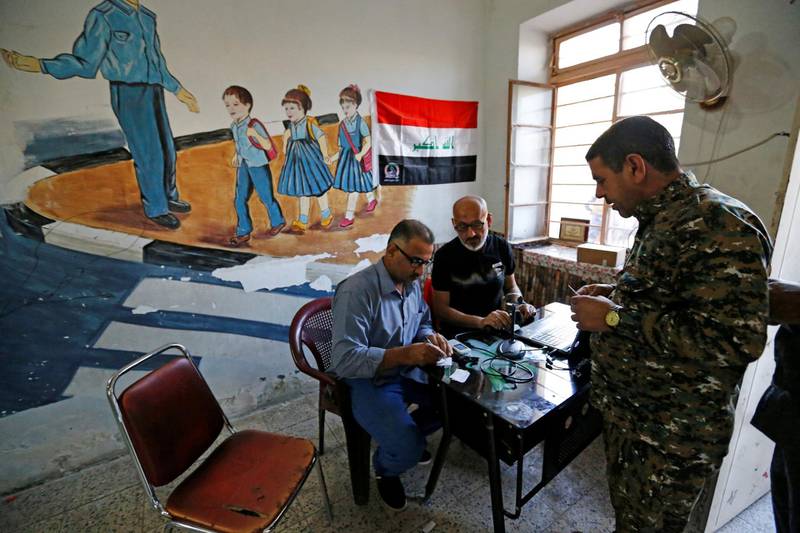 An Iraqi security member arrives to cast his vote at a polling station in Baghdad, Iraq. Thaeir al-Sudani / Reuters