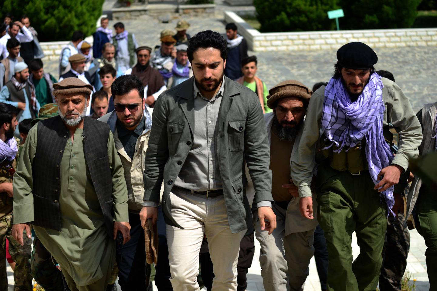 Ahmad Massoud (C) visits the tomb of his late father in Panjshir province. AFP