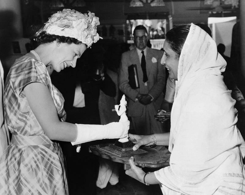 Queen Elizabeth II receives a statuette during a visit in Bangalore as part of a state visit in India on January 1961. Central Press/ AFP