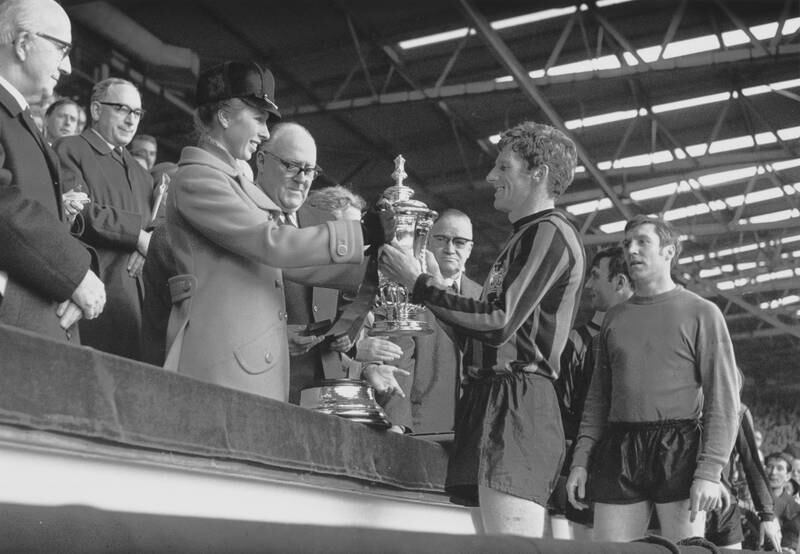 Princess Anne presents the FA Cup to Manchester City captain Tony Book at Wembley Stadium in London in 1969.