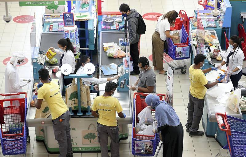 DUBAI, UNITED ARAB EMIRATES , April 29 – 2020 :- People wearing protective face mask to prevent the spread of the coronavirus during the shopping at the Carrefour Hypermarket at Mall of the Emirates in Dubai. Authorities ease the restriction for the residents in Dubai. At present mall opening timing is 12:00 pm to 10:00 pm. Carrefour timing is 9:00 am to 10:00 pm. (Pawan Singh / The National) For News/Standalone/Online. Story by Patrick