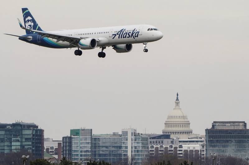 An Alaska Airlines aircraft flies past the US  Capitol before landing at Reagan National Airport in Arlington, Virginia. Reuters
