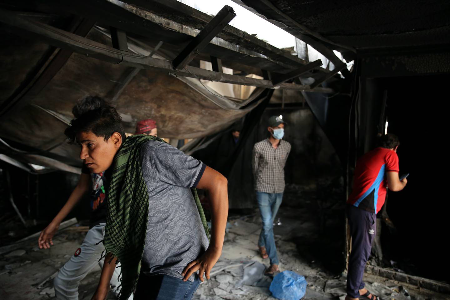 Rescuers and civilians look for bodies after a catastrophic blaze erupted at a hospital in Nasiriyah. AP
