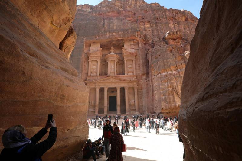 Tourists take pictures in front of the treasury site. Reuters