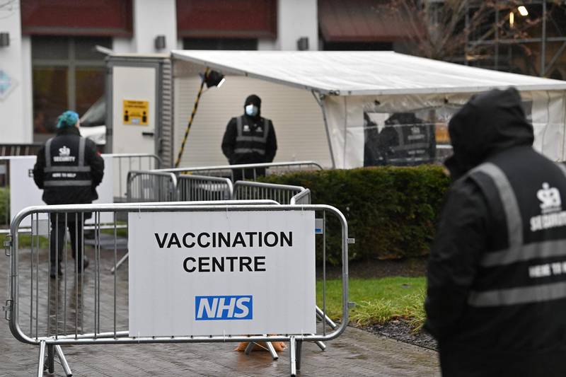 Security stand at the entrance to Blackburn cathedral as it opens as a Covid-19 mass vaccination centre in Blackburn, northwest England on January 18, 2021. AFP