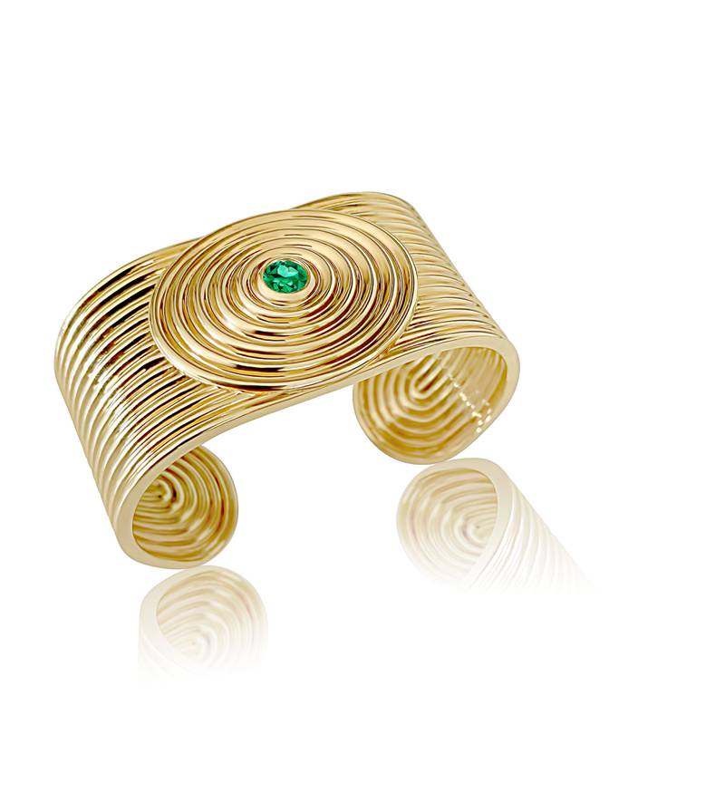 Universum bangle in 18k yellow gold with tsavorite by Almasika, priced at $24,000