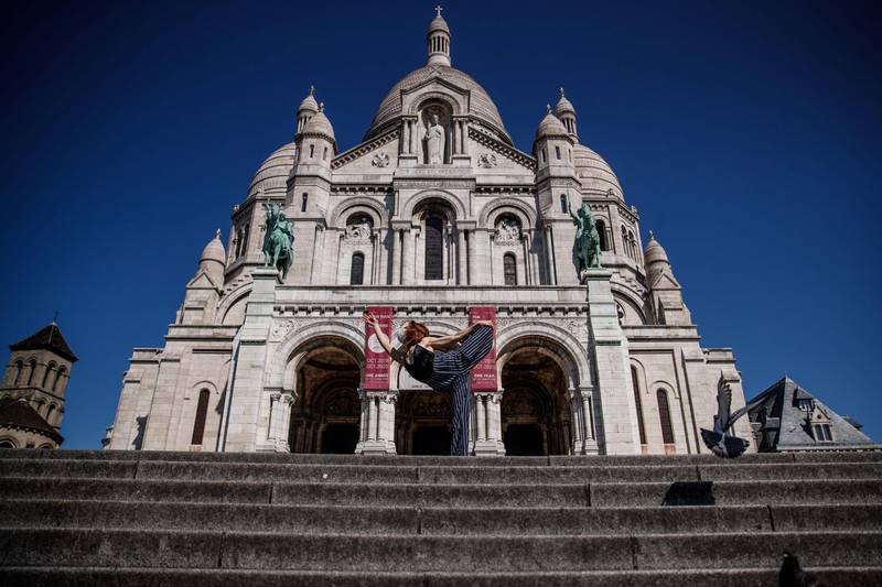 Syrian dancer and choreographer Yara al-Hasbani performs a dance in front of the Sacre Coeur basilica in Paris  on the 37th day of a strict lockdown in France to stop the spread of COVID-19.  AFP