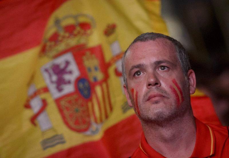 A Spain fan reacts during the team's loss to Chile on Wednesday night at the 2014 World Cup in Brazil while watching on a screen in Madrid. Dani Pozo / AFP / June 18, 2014