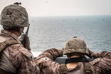 US Marines keep a watch on the Strait of Hormuz. Reuters
