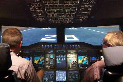 Captain Geert Pruss with The National's aviation reporter David Black, right, in an A380 simulator at Lufthansa's facility in Frankfurt. Courtesy Lufthansa
