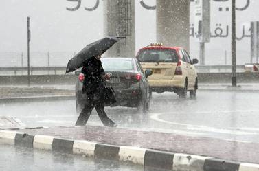 DUBAI, UNITED ARAB EMIRATES , March 22 – 2020 :- One of the commuter caught in the heavy rain in Al Barsha in Dubai. (Pawan Singh / The National) For News/Online/Instagram.