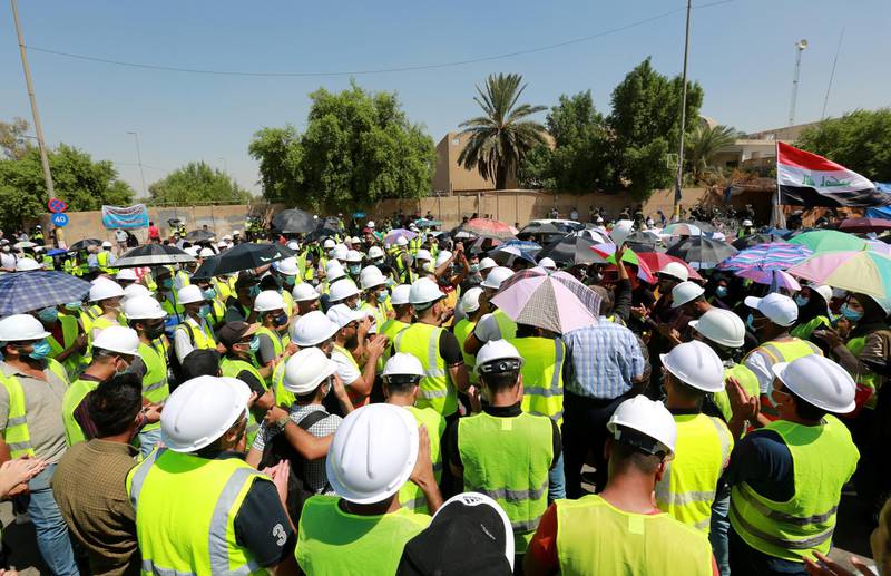epa08673114 Jobless graduates wear hard hats and fluro vests during a protest near the green zone in central Baghdad, Iraq, 16 September 2020. Thousands of university graduates and jobless continue their protests against the lack of job opportunities and basic services, near the heavily fortified Green Zone which houses the Iraqi government offices in Baghdad.  EPA-EFE/AHMED JALIL *** Local Caption *** 56346531