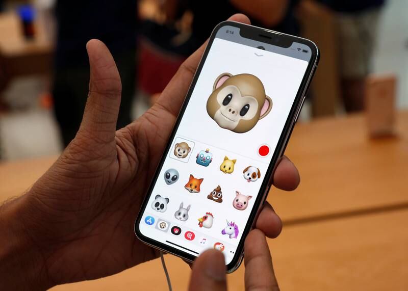 A man tries out the Animoji feature on the iPhone X during its launch at the Apple store in Singapore. Edgar Su / Reuters