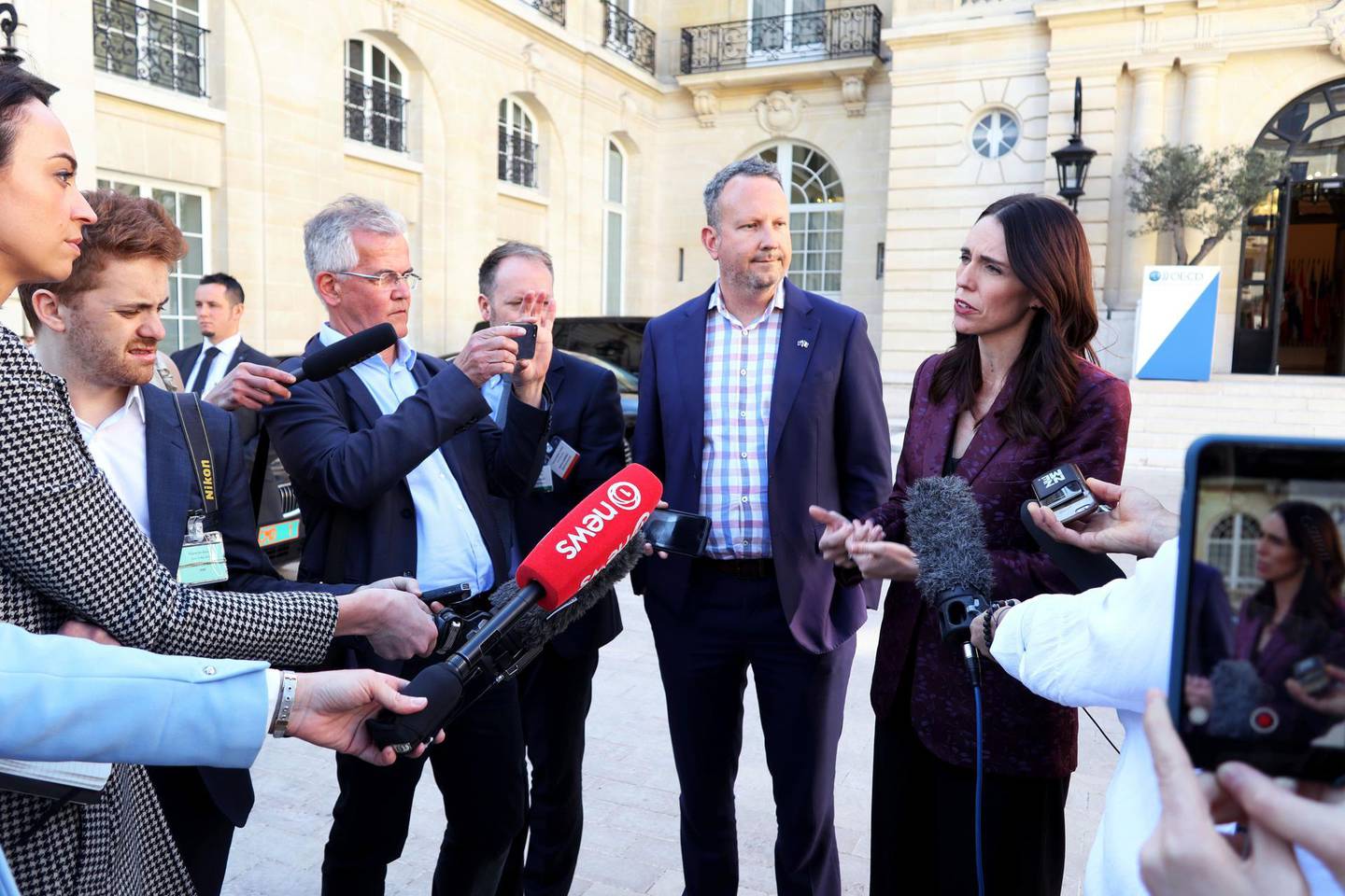 New Zealand Prime Minister Jacinda Ardern, right, gives a press conference, at the OECD headquarters, in Paris, Tuesday, May 14, 2019. The leaders of France and New Zealand will make a joint push to eliminate acts of violent extremism from being shown online, in a meeting with tech leaders in Paris on Wednesday. (AP Photo/Thibault Camus)