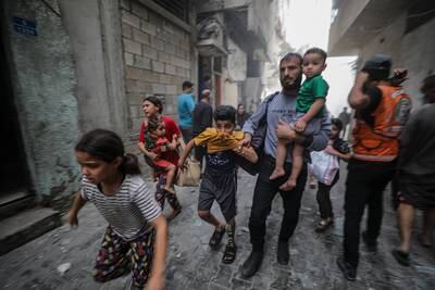 Palestinians flee following an Israeli air strike in Gaza. EPA