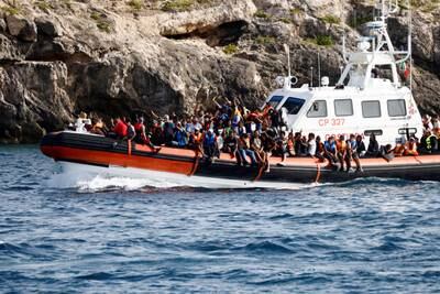 Migrants arrive on an Italian coastguard vessel after being rescued near the Sicilian island of Lampedusa. Reuters