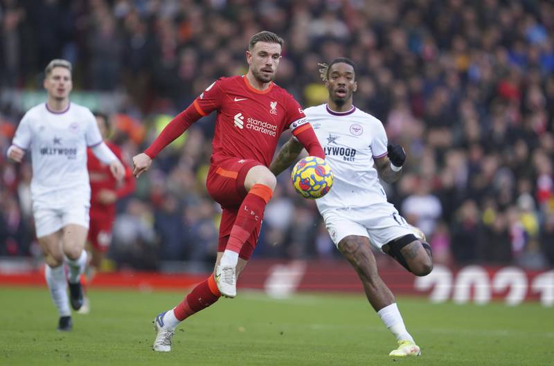 Liverpool midfielder Jordan Henderson is challenged by Brentford striker Ivan Toney. AP
