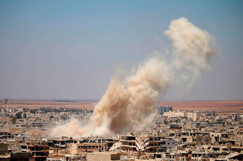 Smoke rises above opposition held areas of Daraa during an airstrike by Syrian regime forces, on June 25, 2018. Russian-backed regime forces have for weeks been preparing an offensive to retake Syria's south, a strategic zone that borders both Jordan and the Israeli-occupied Golan Heights. / AFP / Mohamad ABAZEED
