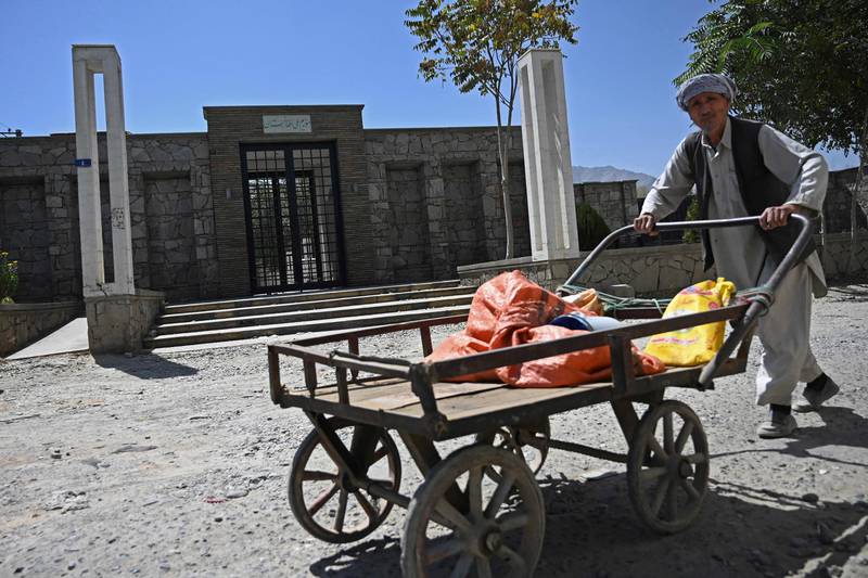 A worker pushes his handcart past the main entrance of the closed National Museum in Kabul. AFP