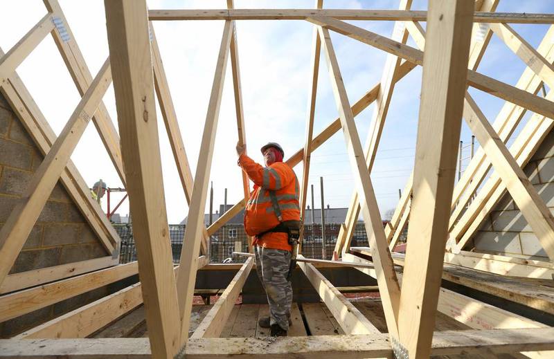 Construction in Britain is firmly back on a growth track as output in December was 2 per cent higher than it was a month earlier. Above, a builder assembles wooden roofing joists on a new home in Bedford. Chris Ratcliffe / Bloomberg News
