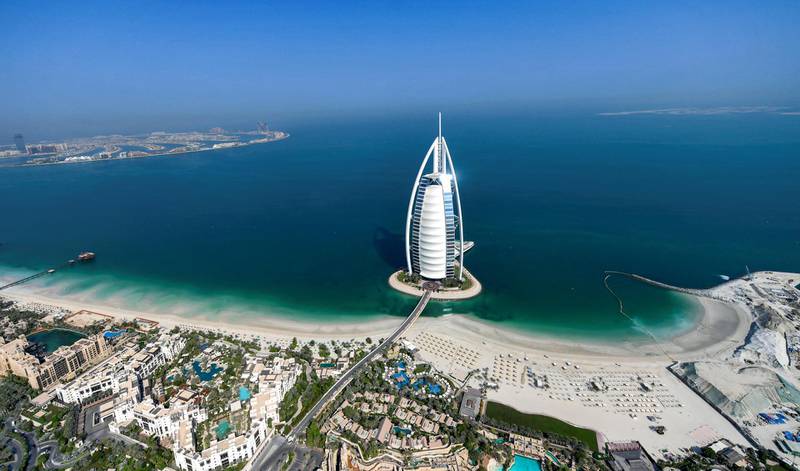 This picture taken on July 8, 2020 shows an aerial view of the Burj al-Arab hotel in the Gulf emirate of Dubai, during a government-organised helicopter tour. (Photo by KARIM SAHIB / AFP)