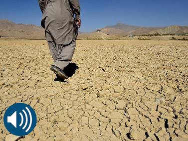 A Pakistani villager walks on the cracks of the dry Hanna Lake in the Urak Valley. A UN report has said that the earth is facing an unprecedented crisis due to global warming, which was addressed at this week's COP24 summit. AFP