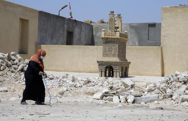 A woman walks past the rubble of the Cairo Necropolis in Cairo, Egypt.  EPA