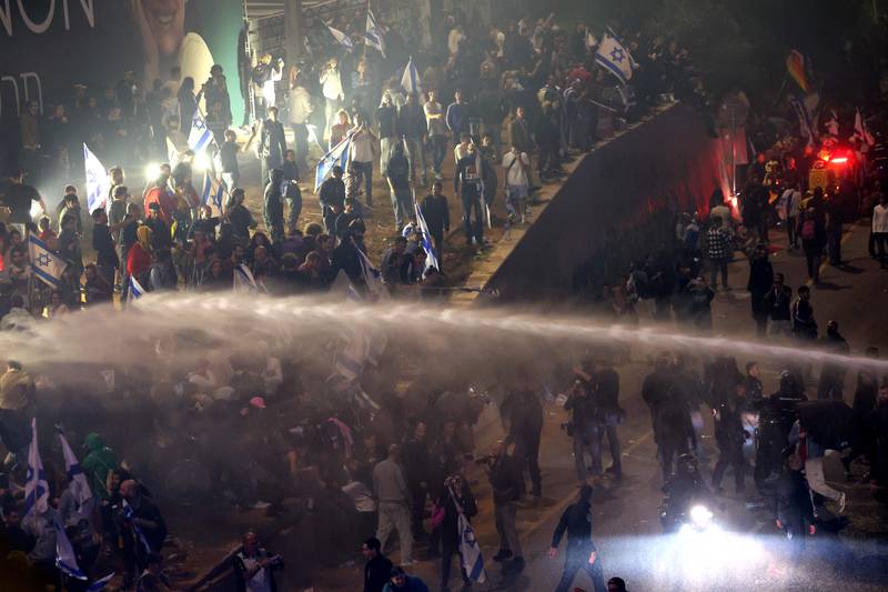 Police use a water cannon on violent protesters in Tel Aviv. AFP