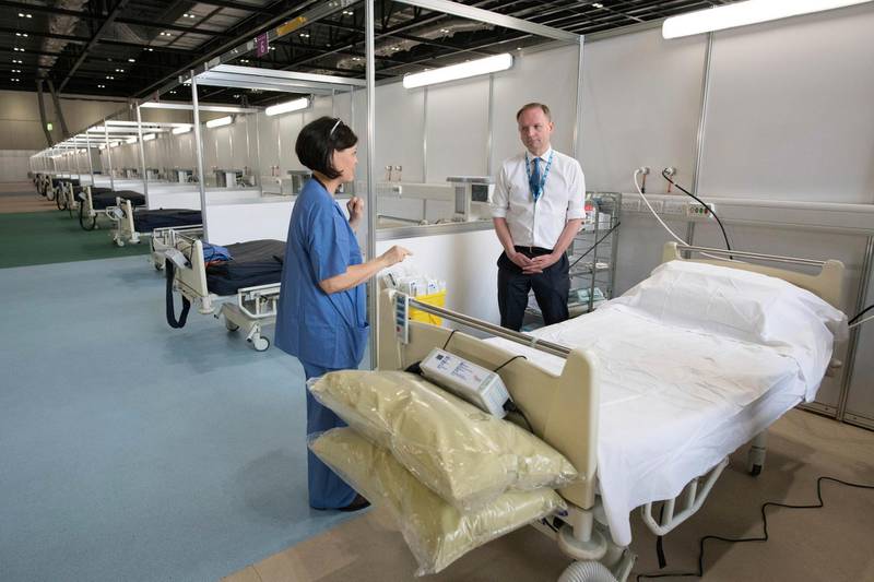 NHS England's chief executive Simon Stevens is shown around the Nightingale hospital. AP