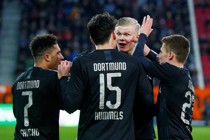 Dortmund's Jadon Sancho celebrates scoring their third goal with teammates. Reuters