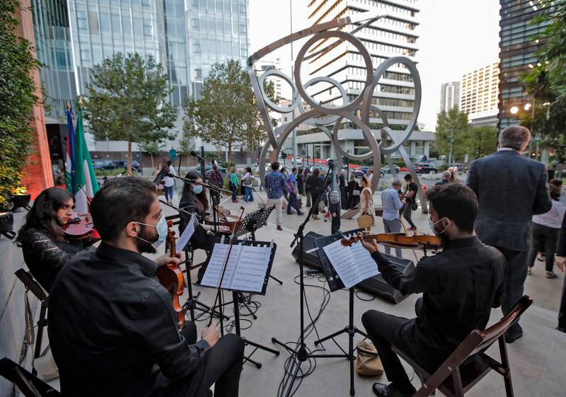 Musicians perform at the inauguration of a sculpture by Lebanese artist Nayla Romanos Iliya titled 'On the Other Side of Time', a permanent artwork erected in front of the church or St Elias, in Beirut, on October 20. AFP