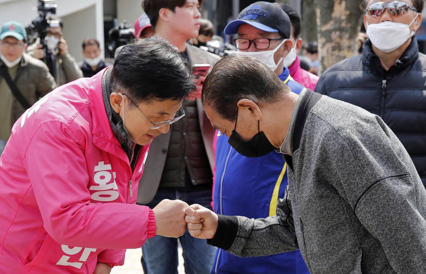 Hwang Kyo-ahn, a candidate of the main opposition United Future Party, gives a fist bump instead of shaking hands to avoid the spread of the coronavirus disease (COVID-19) during a campaign rally in Seoul,?South Korea, April 10, 2020.    REUTERS/Heo Ran