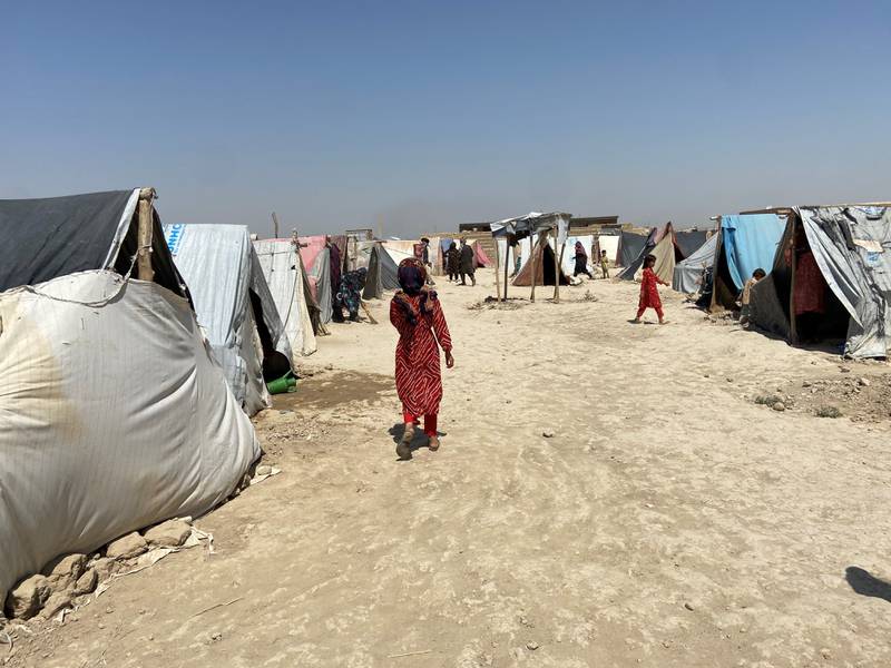 A young girl walks through a camp for internally displaced people, administered by the United Nations High Commission for Refugees in northern Afghanistan. Photo: Ruchi Kumar for The National.