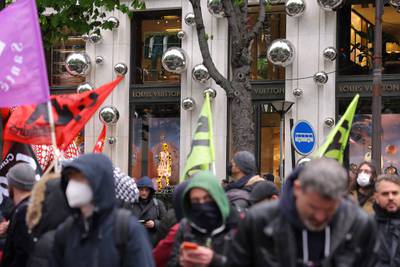 Demonstrators stand in front of the Louis Vuitton store. AFP