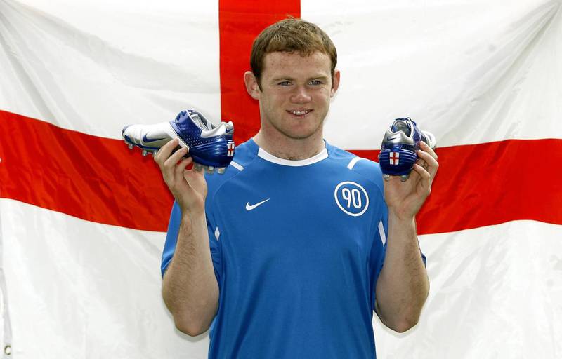 Manchester United and England player Wayne Rooney poses with his new boots during a photocall at Old Trafford on April 25, 2006. PA
