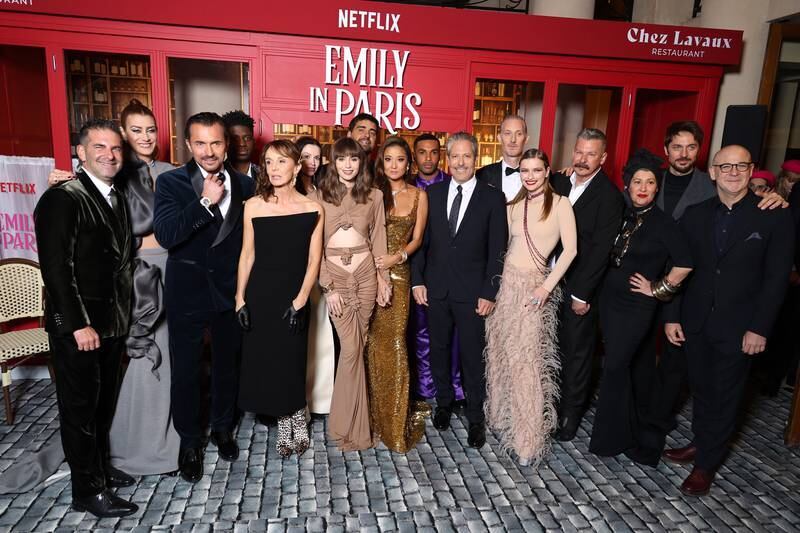 From left, Stephen Brown, Kate Walsh, William Abadie, Samuel Arnold, Philippine Leroy-Beaulieu, Lily Burns, Lily Collins, Tony Hernandez, Ashley Park, Lucien Laviscount, Darren Star, Bruno Gouery, Camille Razat, Andrew Fleming, Marylin Fitoussi, Lucas Bravo, and Peter Friedlander at the Emily In Paris season three world premiere at Theatre Des Champs Elysees on December 6 in Paris. Getty Images