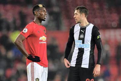 Manchester United's French midfielder Paul Pogba (L0 chats with Newcastle United's French midfielder Florian Lejeune (R) on the pitch after the English Premier League football match between Manchester United and Newcastle United at Old Trafford in Manchester, north west England, on December 26, 2019. - Manchester United won the game 4-1. (Photo by Paul ELLIS / AFP) / RESTRICTED TO EDITORIAL USE. No use with unauthorized audio, video, data, fixture lists, club/league logos or 'live' services. Online in-match use limited to 120 images. An additional 40 images may be used in extra time. No video emulation. Social media in-match use limited to 120 images. An additional 40 images may be used in extra time. No use in betting publications, games or single club/league/player publications. / 