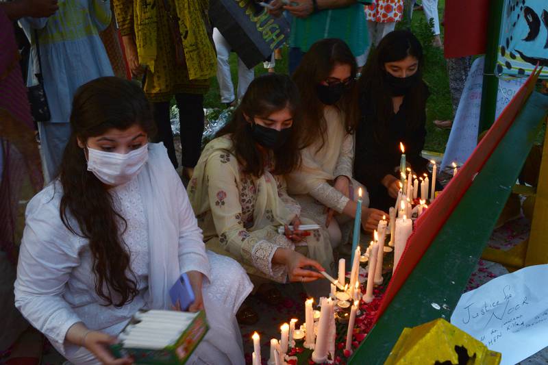 Women rights activists light candles at a park in Islamabad, against the brutal killing of Noor Mukadam, the daughter of former Pakistan envoy to South Korea, in the federal capital earlier this week. AFP
