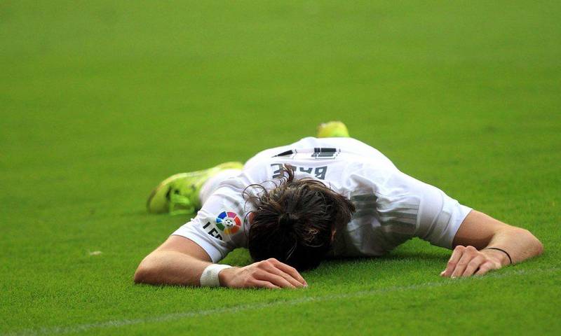 Real Madrid's Gareth Bale lies on the pitch during their goalless draw with Sporting Gijon on Sunday in La Liga. Jose Cereijido / EPA / August 23, 2015