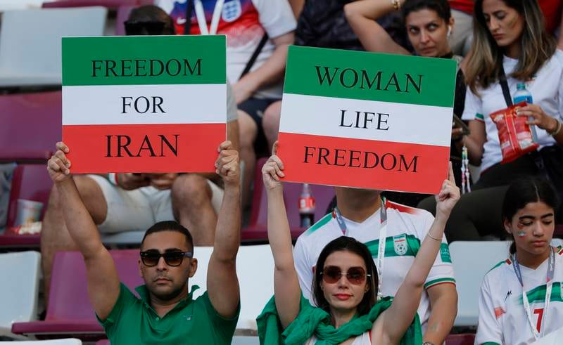 Iran supporters make a point before the match with England at Khalifa International Stadium in Doha. EPA