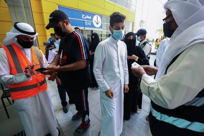Officials check the vaccination certificates of people entering The Avenues Mall, the largest shopping centre in Kuwait. AFP