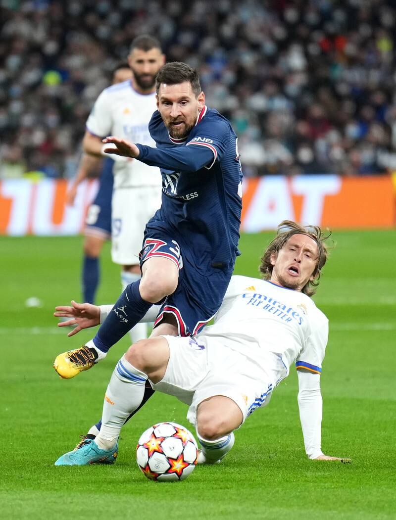 Lionel Messi is tackled by Luka Modric. Getty