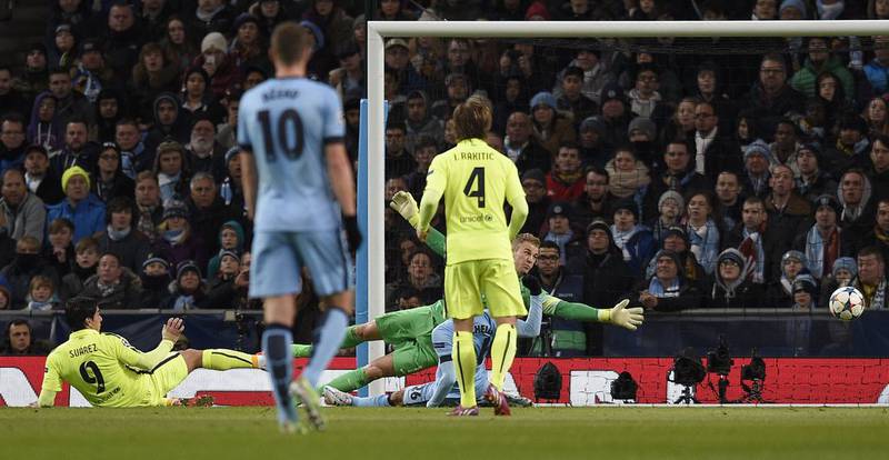Barcelona's Luis Suarez scores his and his team's second goal against Manchester City on Tuesday night in their 2-1 Champions League last 16 first leg win. Lluis Gene / AFP