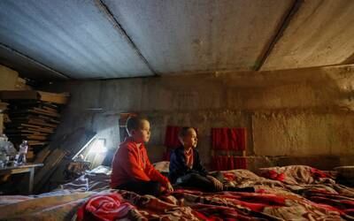 Children sit inside a bomb shelter in Rubizhne. Reuters
