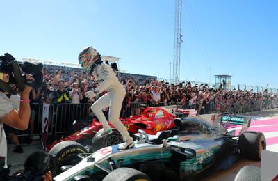 Mercedes driver Lewis Hamilton leaps out of his car to celebrate his win as closes in on his fourth world title. Srdjan Suki / EPA