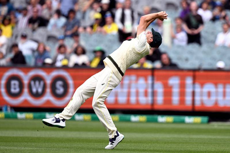Pat Cummins takes a catch to dismiss South African batsman Keshav Maharaj. AFP