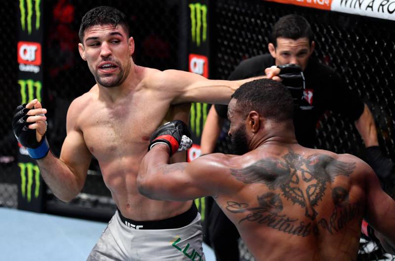 Vicente Luque punches Tyron Woodley in their welterweight fight. Jeff Bottari / USA TODAY Sports / Reuters