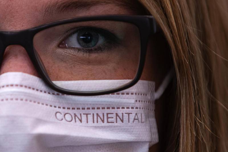 An employee wears a Continental-branded protective face mask at the Continental AG factory in Hanover, Germany. Bloomberg